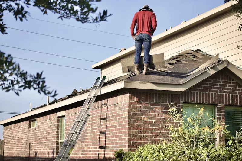 Professional roofer working on a residential roof in Pearsall